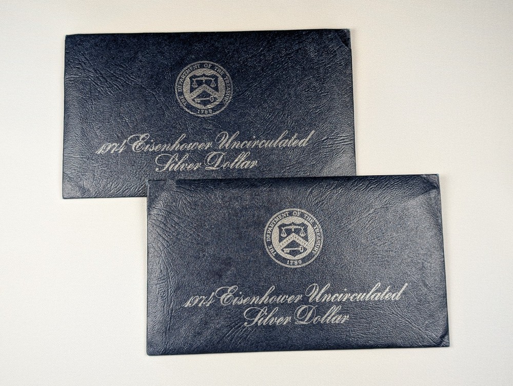 Two (2) 1974 Eisenhower 'Ike' Silver Dollars, Uncirc. Blue Envelope, 2 Coins