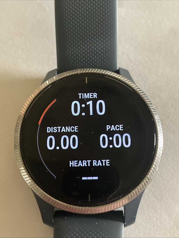 Garmin Venu EUC GPS Smartwatch with charger.