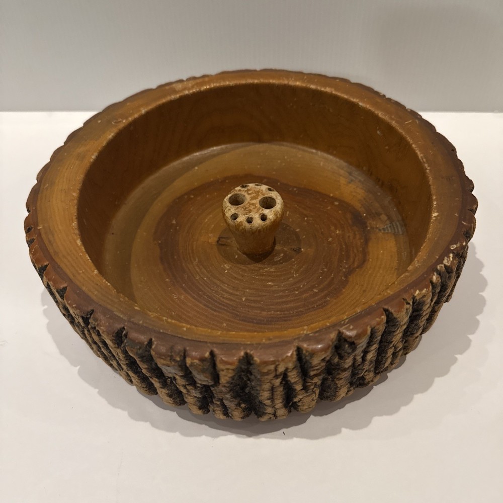 Vintage wooden nut bowl with rustic tree bark,