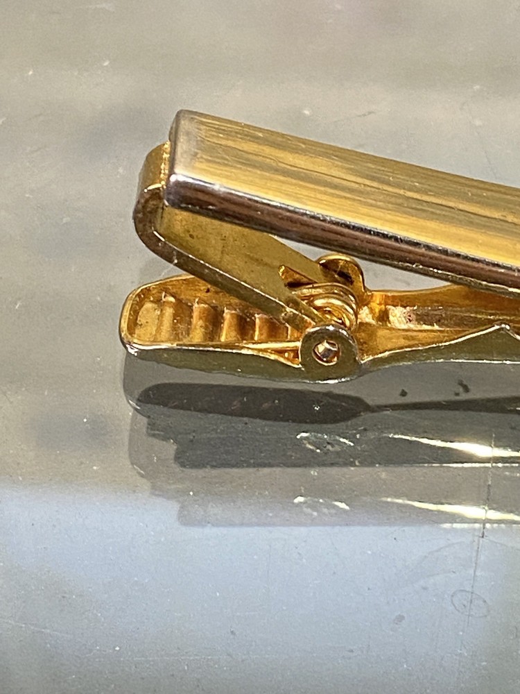 Two Tie Clips, One Marked Anson