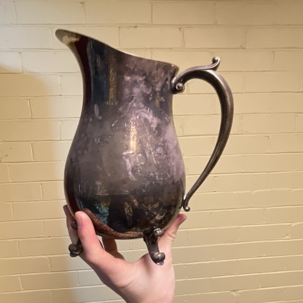 Antique Silverplate Footed Pitcher with Ornate Handle and Decorative Base