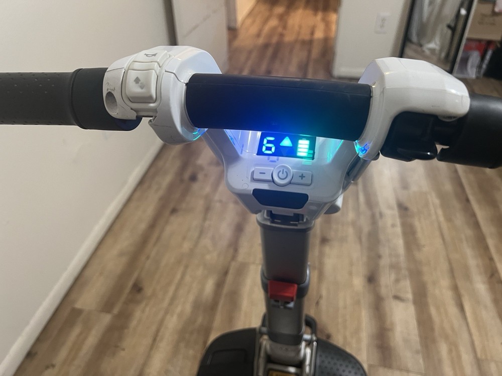 Atto folding scooter color black and white three wheels solid tires