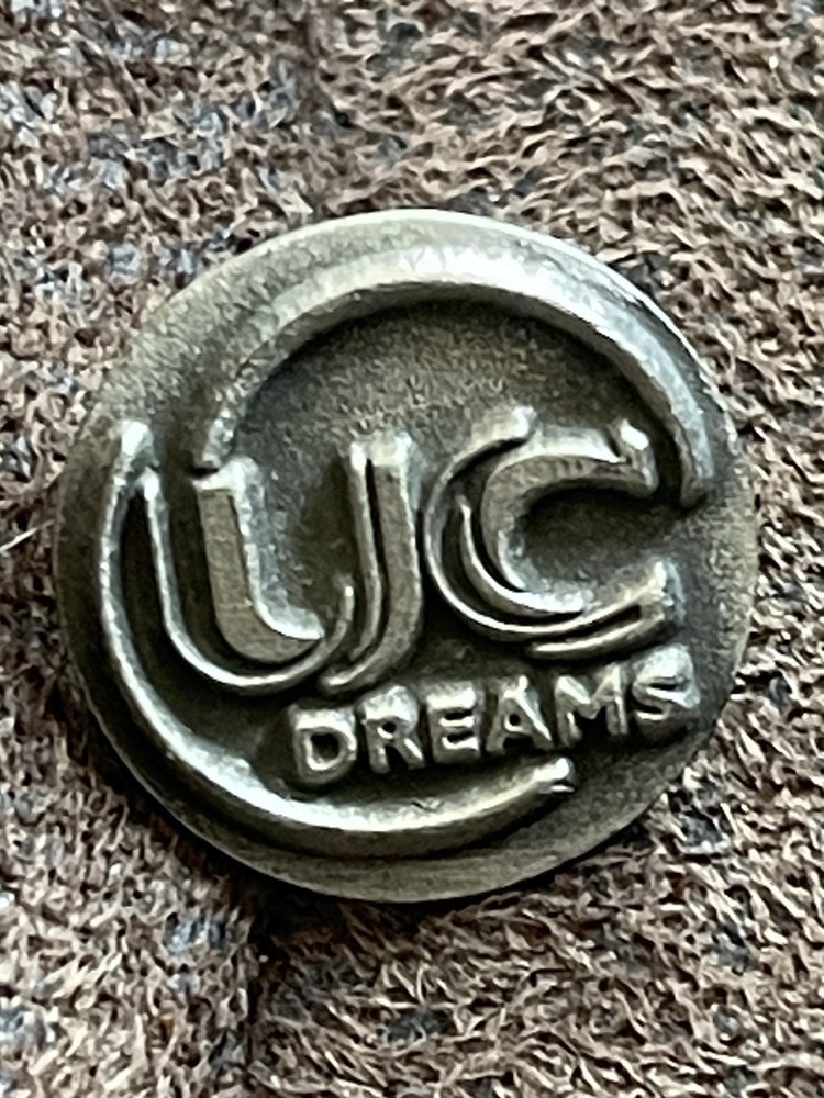 promotional or commemorative UC Dreams token or pin