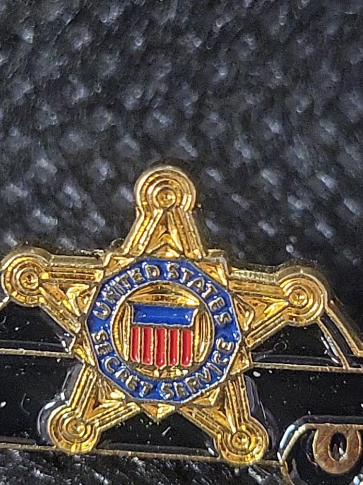 Secret Service Pins A Car And A Shield