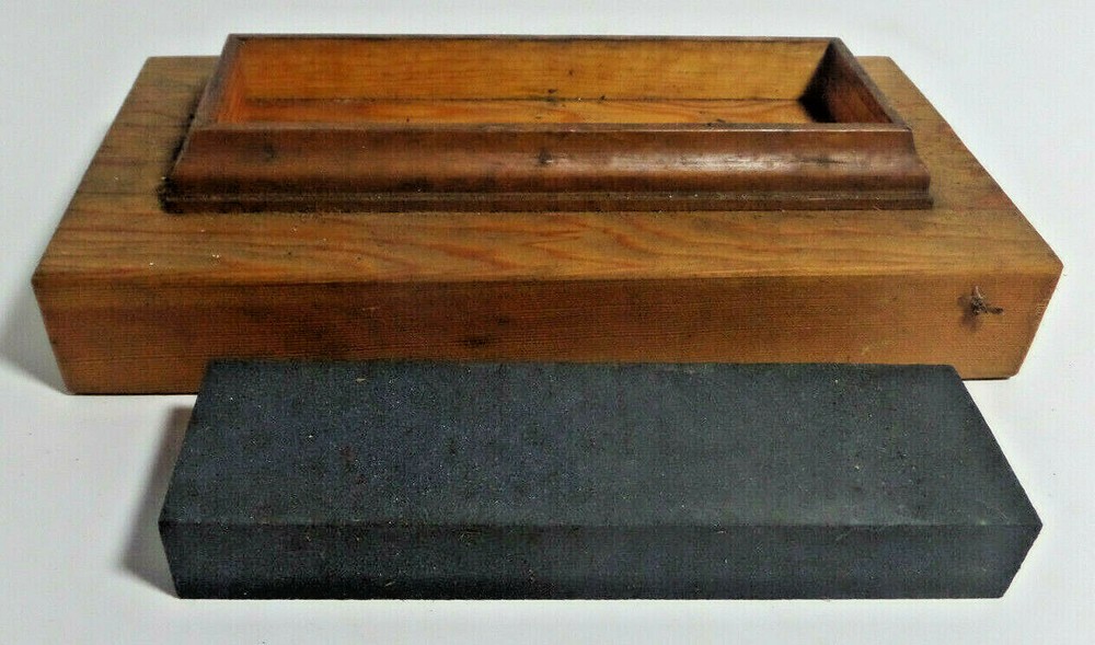 sharpening stone mounted on wood base