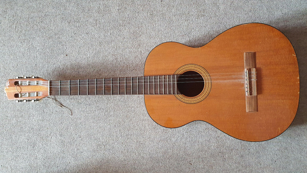 Old guitar with a nicely flamed back,  needs service