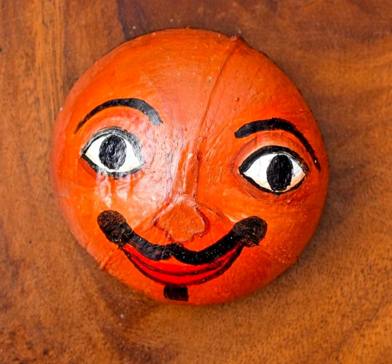 Coconut shells hand painted with different faces specified for hotel decorations