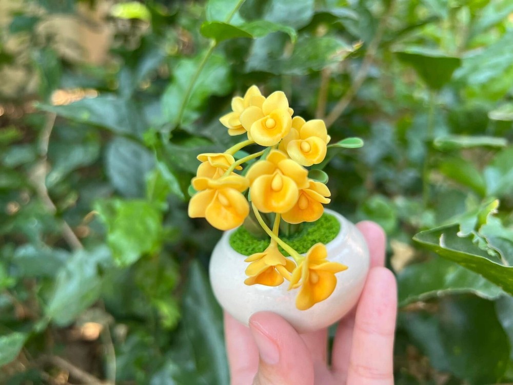 Tiny yellow orchids made by hand from clay