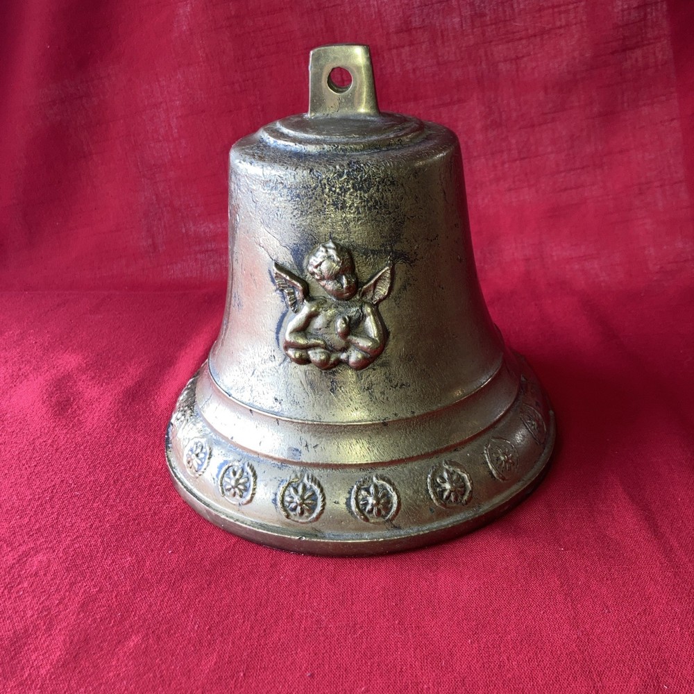 Heavy brass bell with Cupid on each side.