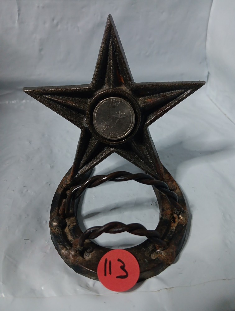 rustic, cast iron desk item featuring a horseshoe base and a large, five-pointed
