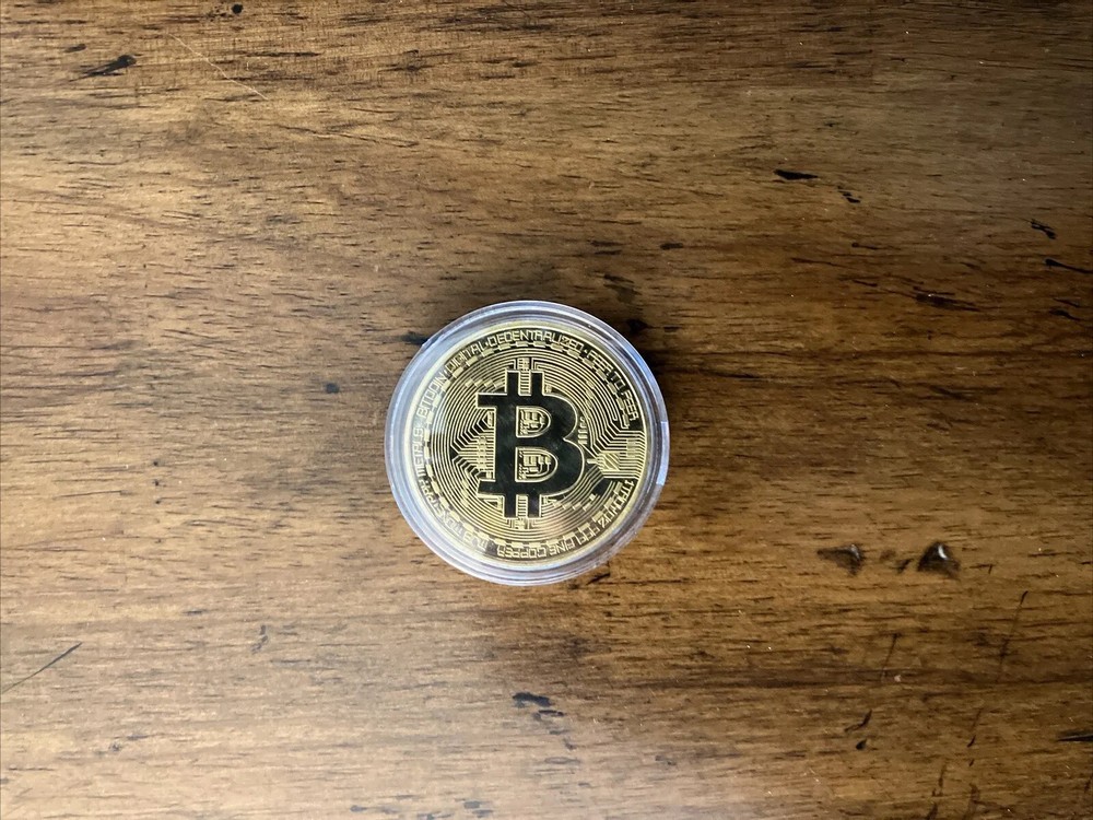 Bitcoin - gold colored Bitcoin in protective case.