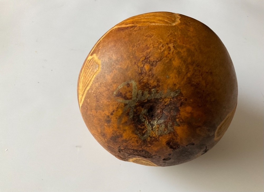 Decorative gourd etched with fish.