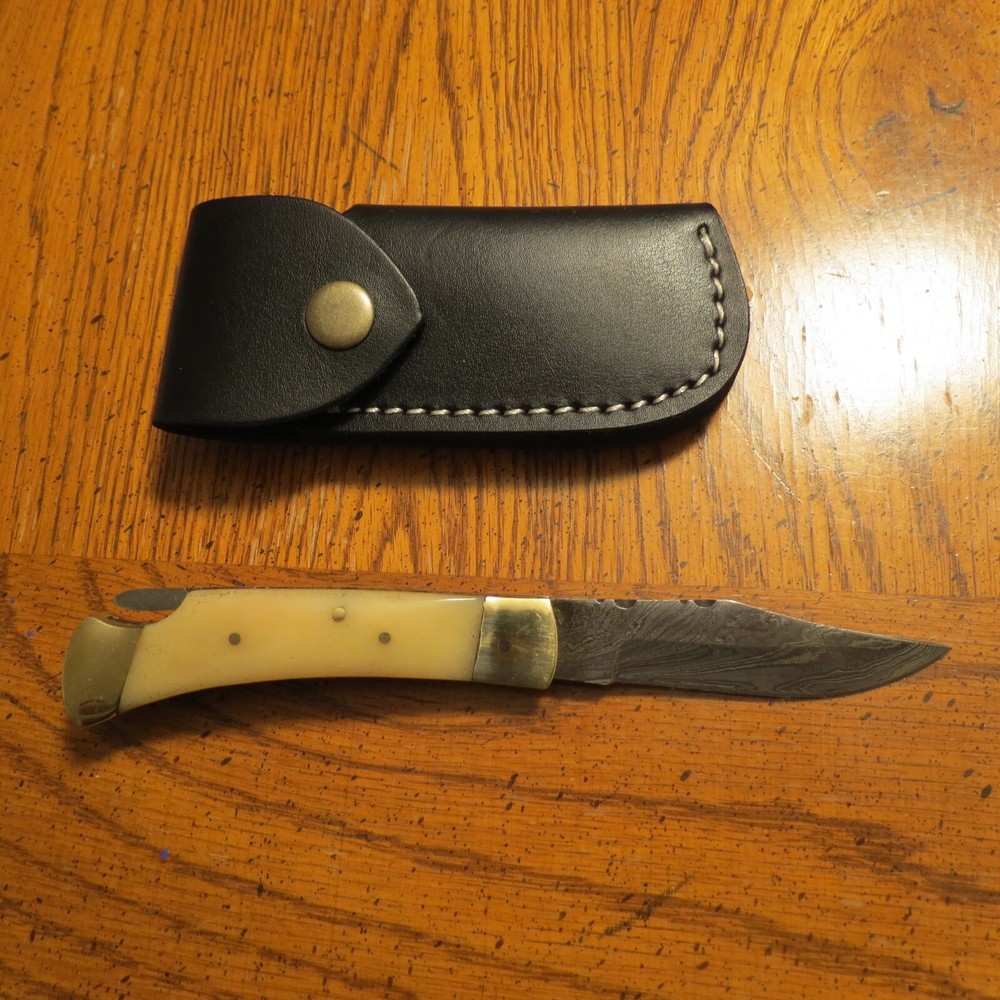 Sleek Damascus folding blade knife with white bone & leather sheath hand made