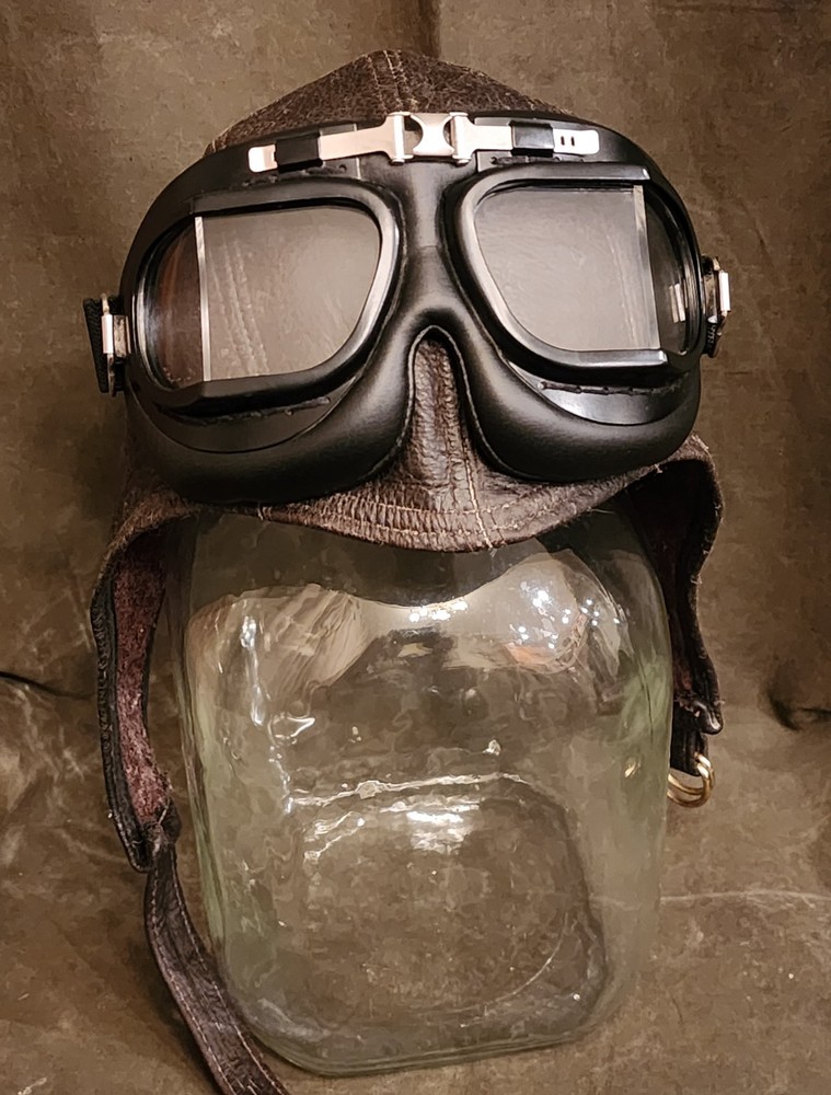 LEATHER AVIATOR FLYING CAP AND GOGGLES .