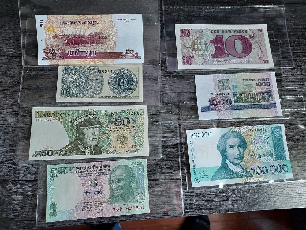 World currency album with 13 uncirculated notes and COA's for all notes