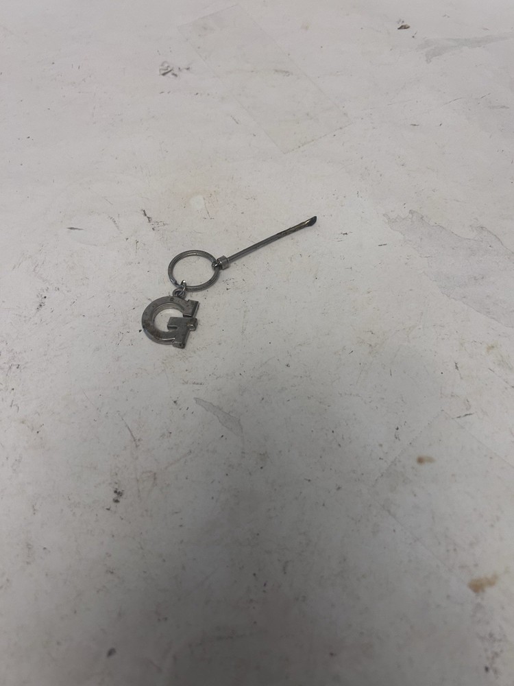 "G" keychain with small spoon scooper used