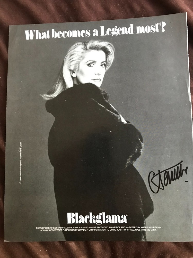 Authentic Catherine Deneuve autograph on magazine advertisement