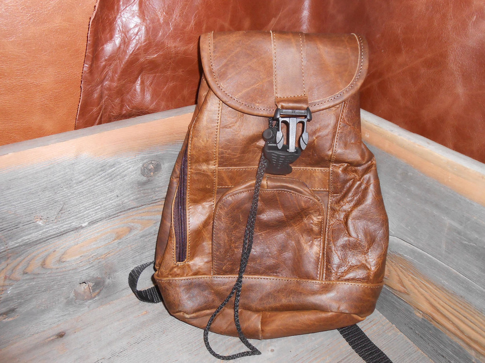 Leather backpack.New small to medium sized backpack spacious with zipper pockets