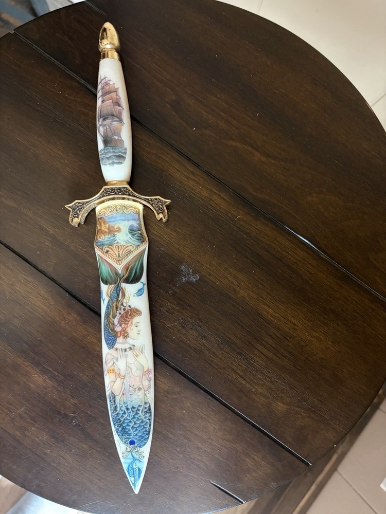 Dagger with pseudo-scrimshaw mermaids