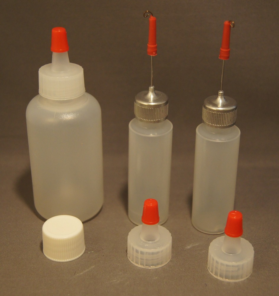 THREE PLASTIC SQUEEZE BOTTLES