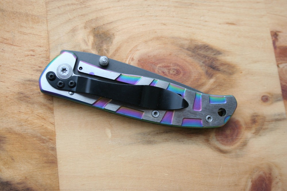 Gentleman frame lock folding knife with rainbow anodized handle. 17.6 cm overall