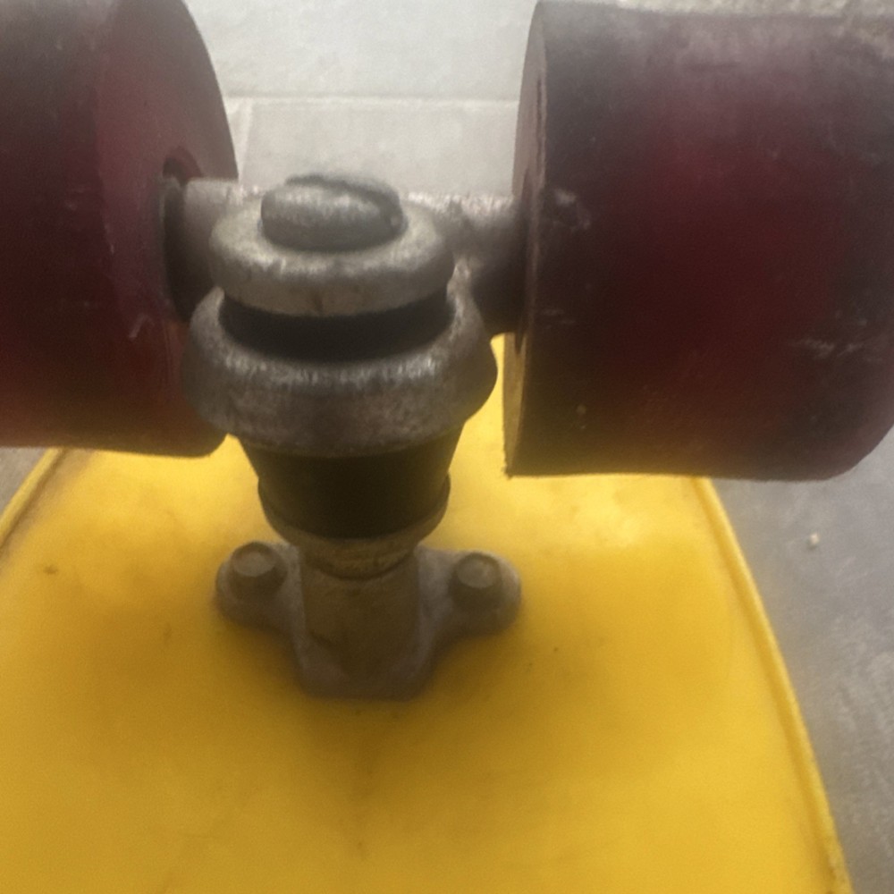 Silver Skateboard Trucks Red Wheels Mounted on Yellow Deck