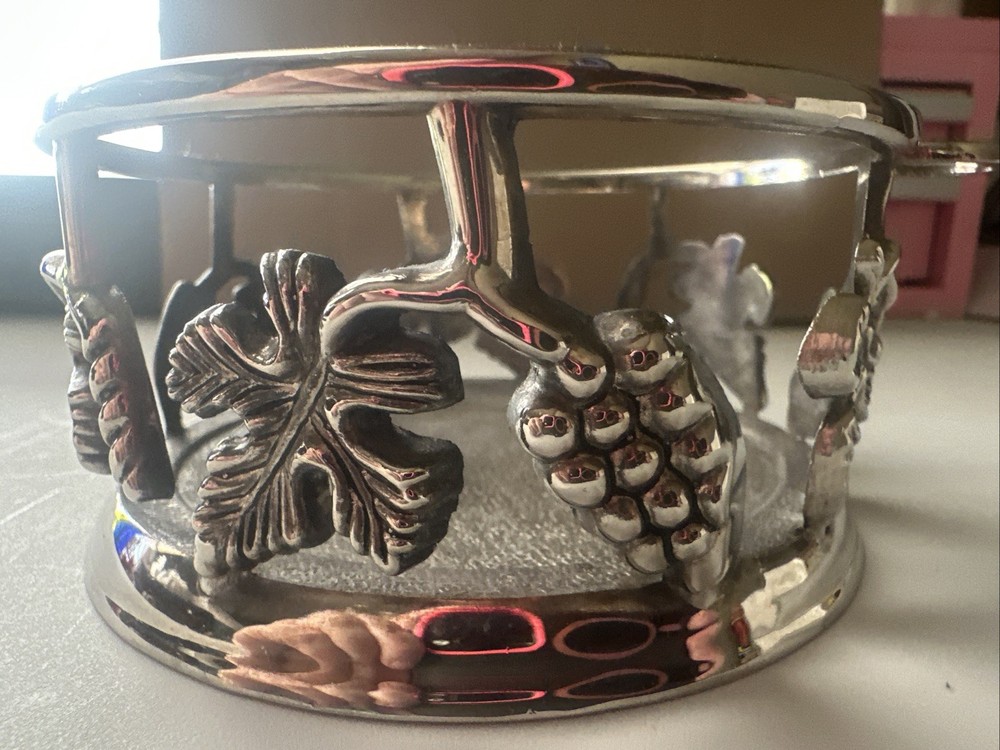 vintage, silver-plated wine bottle coaster featuring intricate grapevine pattern