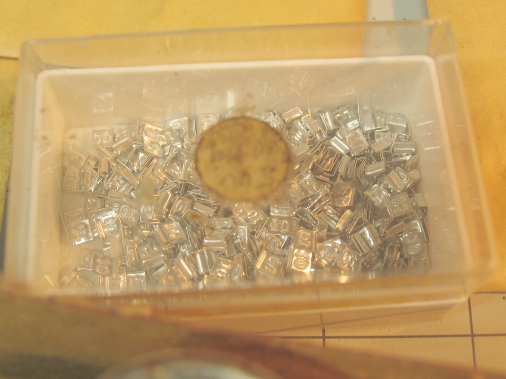 Collection of tiny marked weights 5mg-500mg.