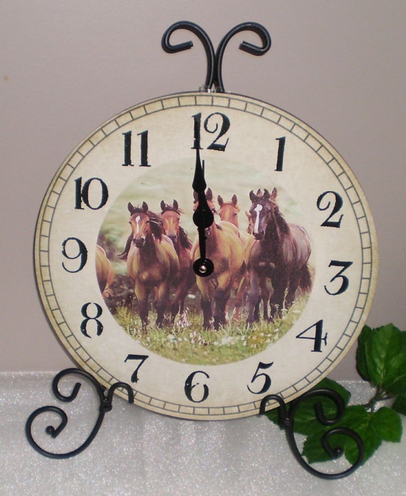 ~~GALLOPING THOROUGHBRED HORSES CLOCK MOUNTED ON BLACK SCROLL STAND~~