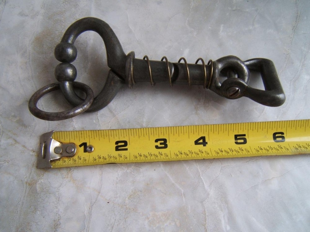 ANTIQUE SPRING-LOADED CAST-IRON BULL LEADING TOOL