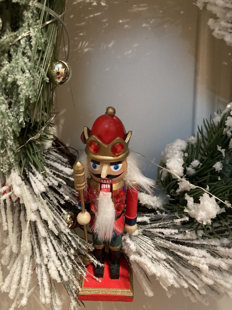 The Nutcracker Wreath With A Red And Green Ribbon