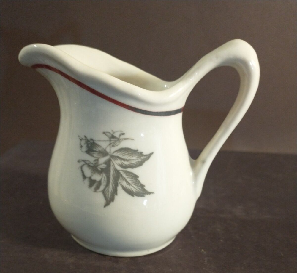 McNicol small creamer with glaze damage on handle