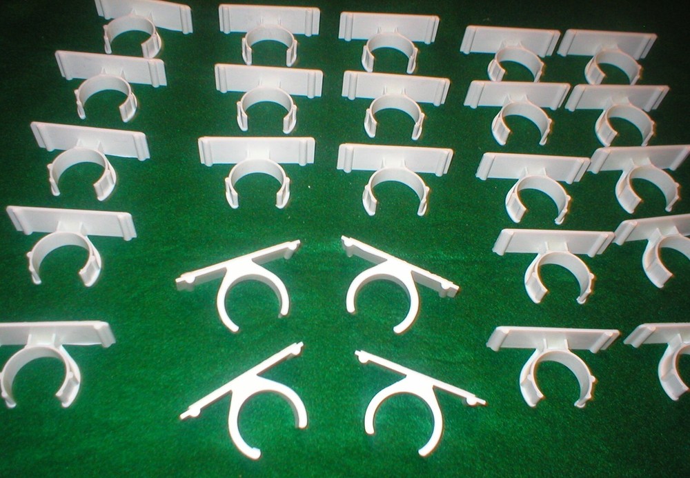25 WHITE PLASTIC HOLDERS WITH ADHESIVE STRIPS LOT SOLD AS IS