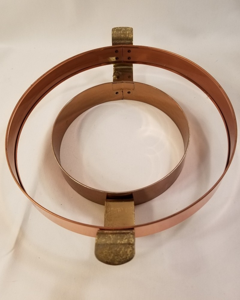 Copper and brass dish holder includes white ruffled dish