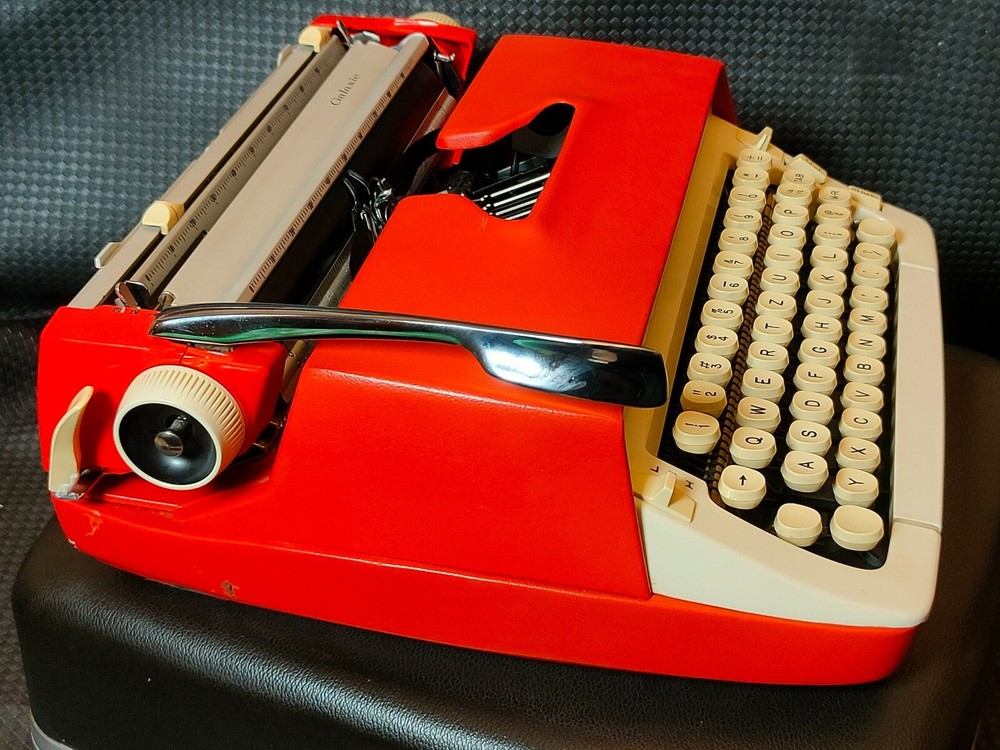 red, portable Smith Corona Galaxie typewriter with Cursive / Handwritten Script