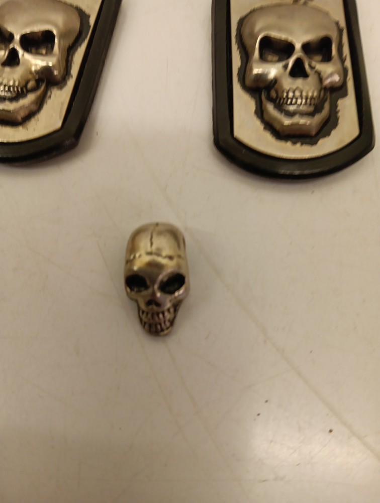 Two Driven Skull Dog Tags And Miniature Skull