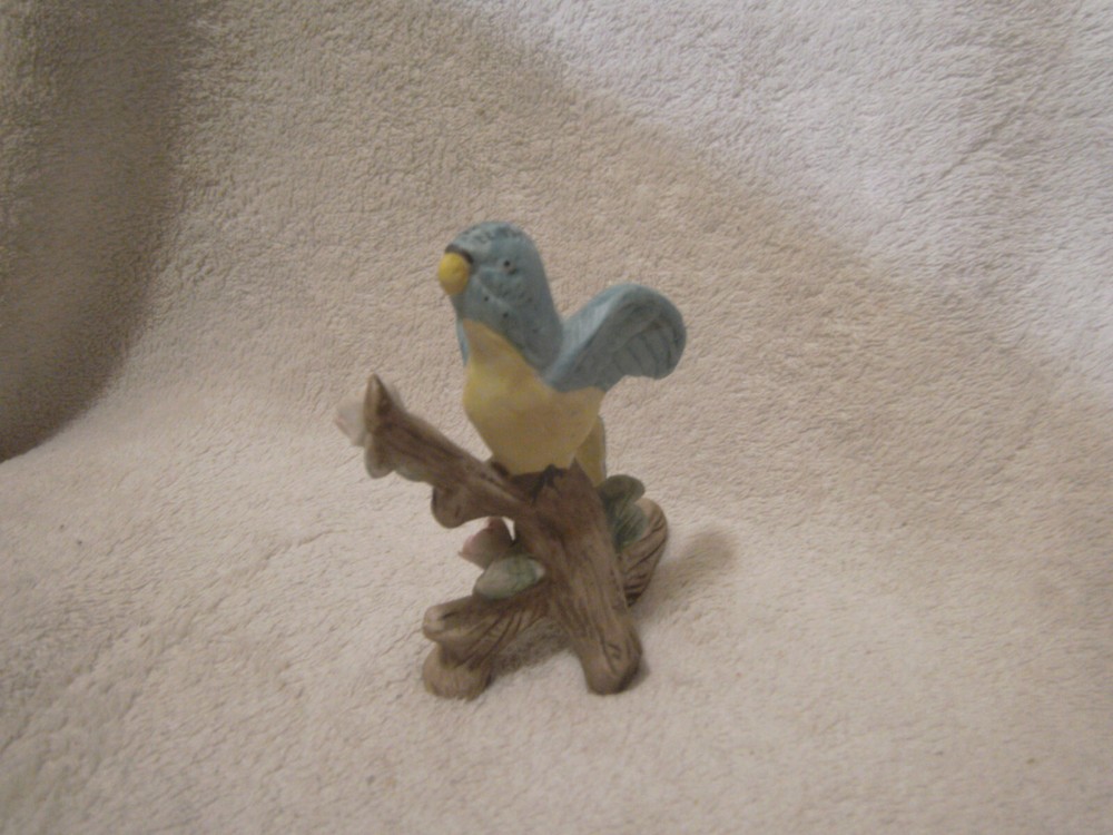 Blue ceramic parrot on tree branch 4 1/2 inches tall