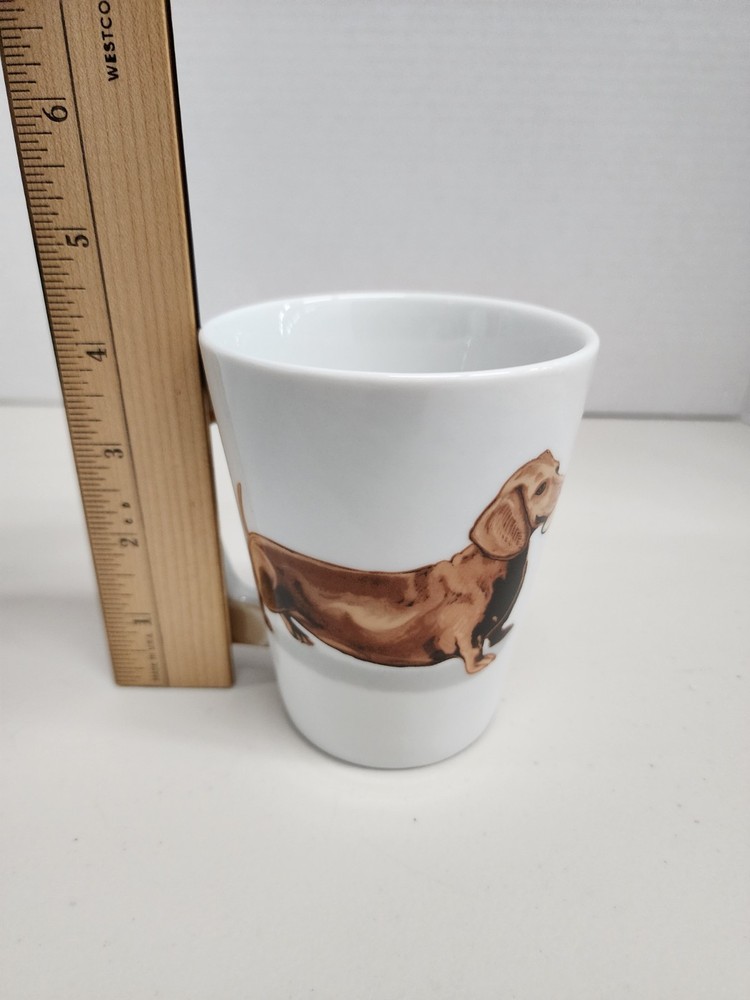 white ceramic mug featuring a brown dachshund design with a distinctive dog