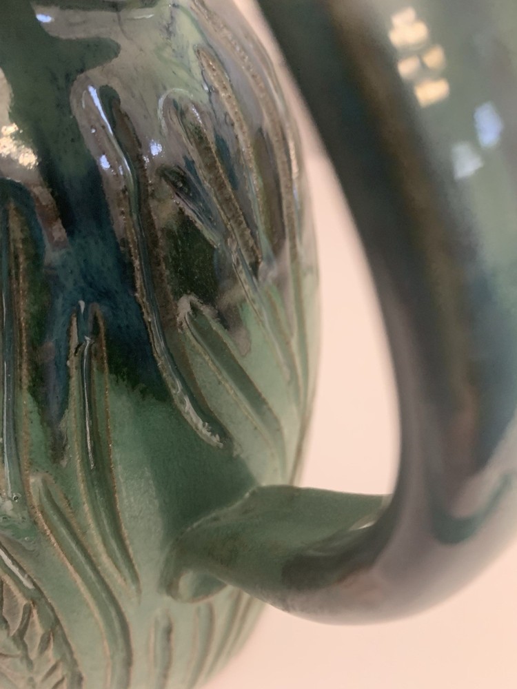 Signed Handcrafted Pottery Pitcher W/ Teal Green Glaze & Raised Leaf Pattern