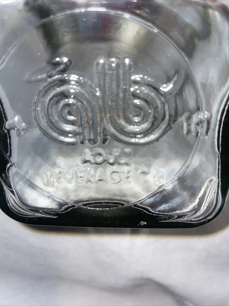 Clear bottle with latch lid- bottom has a b on it