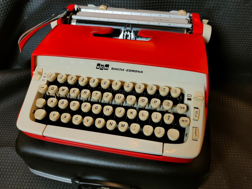 red, portable Smith Corona Galaxie typewriter with Cursive / Handwritten Script