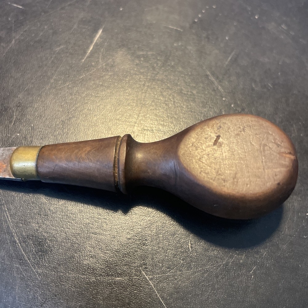 Wood handled screwdriver style tool with brass sparrow