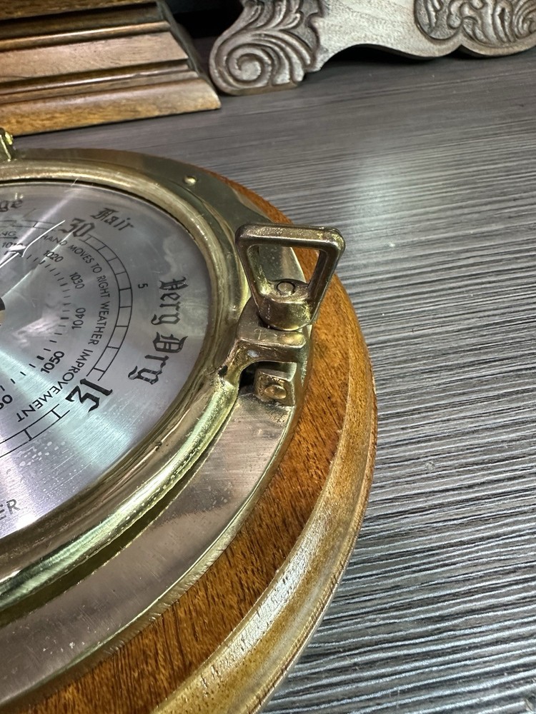 Brass Porthole Barometer on Oak Wood.