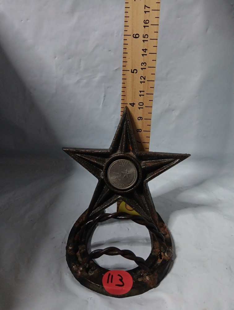 rustic, cast iron desk item featuring a horseshoe base and a large, five-pointed