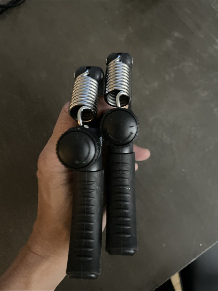 Two Handheld grip strength trainers - black - grey