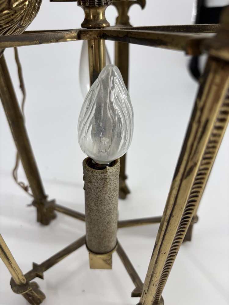 This is an antique lantern chandelier featuring fleur-de-lis finials.