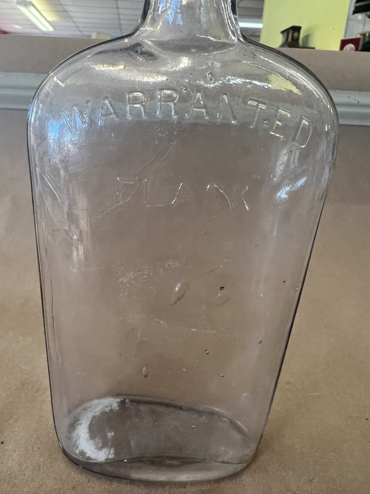 EMBOSSED WARRANTED FLASK C-14 ON BOTTOM CLEAR GLASS