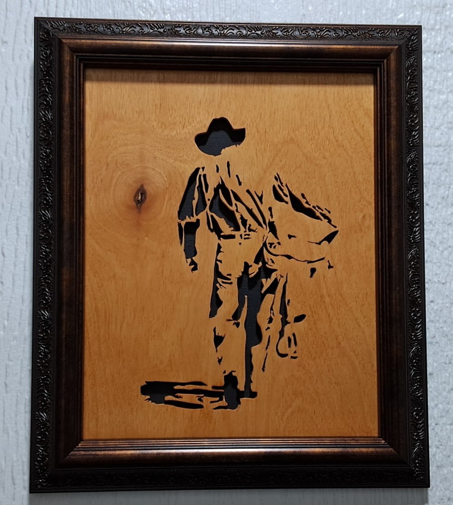 Cowboy with Saddle Handcut scrollsaw, framed, varnished, black backing