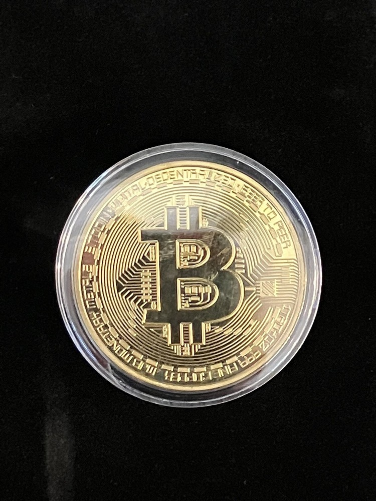Bitcoin - gold colored Bitcoin in protective case.