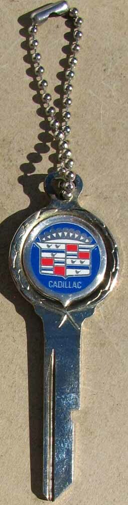 NOS CADILLAC LOGO KEY UNCUT PRISTINE CONDITION #H531